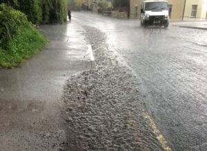 Blocked gullys and flooding road run off